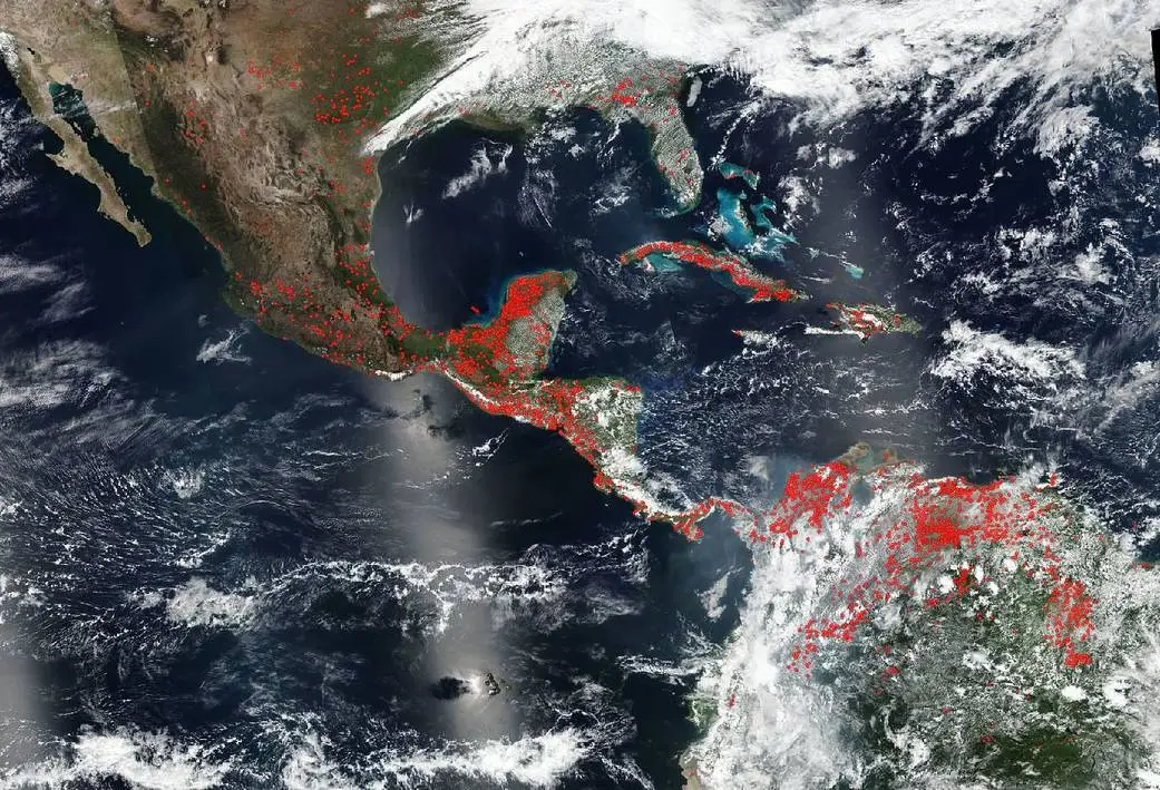A Masa image shows fires burning across the Yucatan Peninsula of Mexico, Central America, and the upper part of South America as highlighted by the red marks in 2020