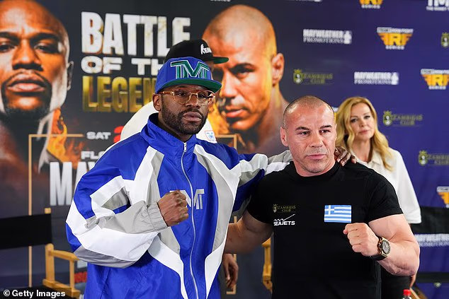 Mayweather (L) and kickboxer Mike Zambidis (R) pose during a news conference to announce their upcoming full-contact exhibition match