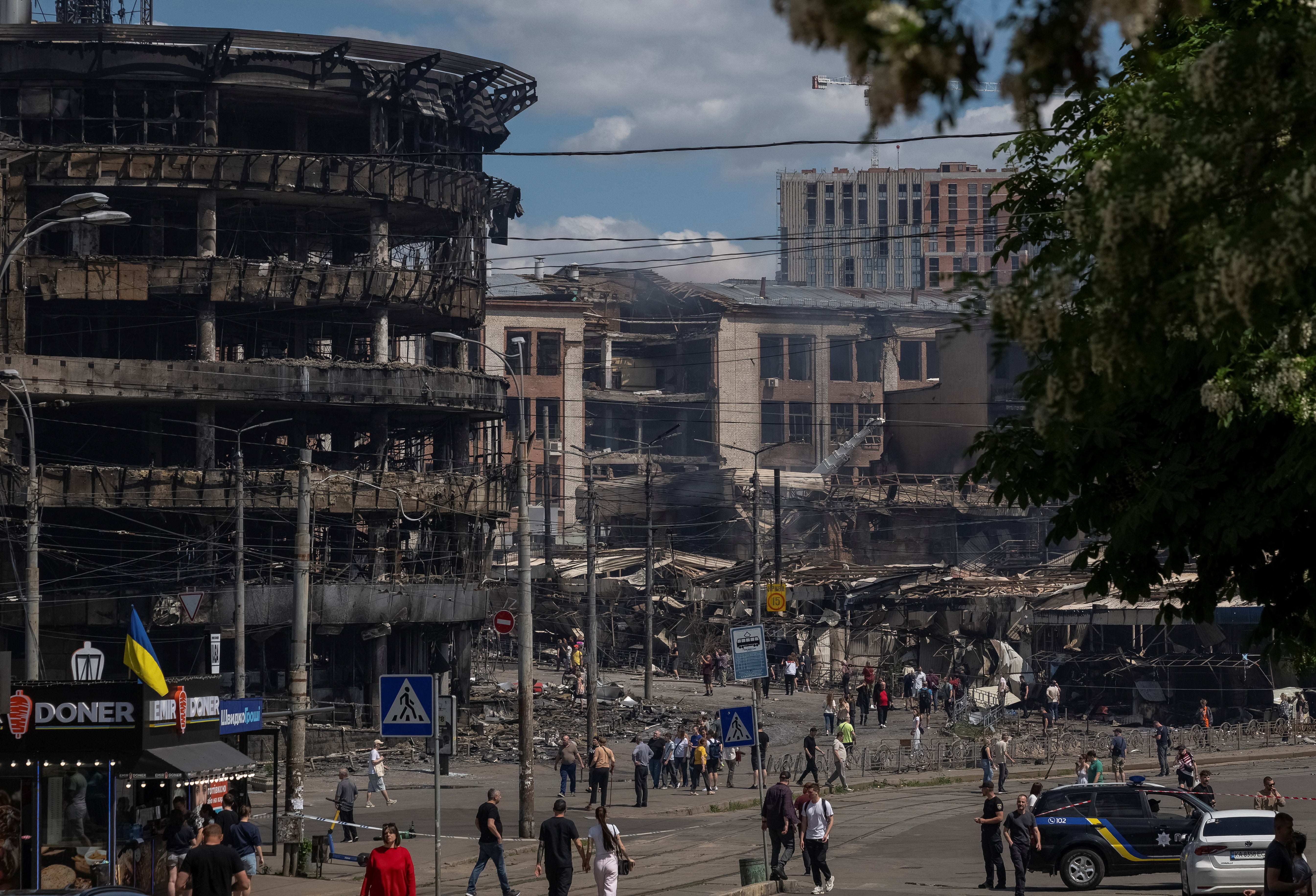 Stanovnici hodaju ulicom na mjestu napada ruske rakete i drona, usred ruskog napada na Ukrajinu, u Kijevu, Ukrajina 24. svibnja 2026.