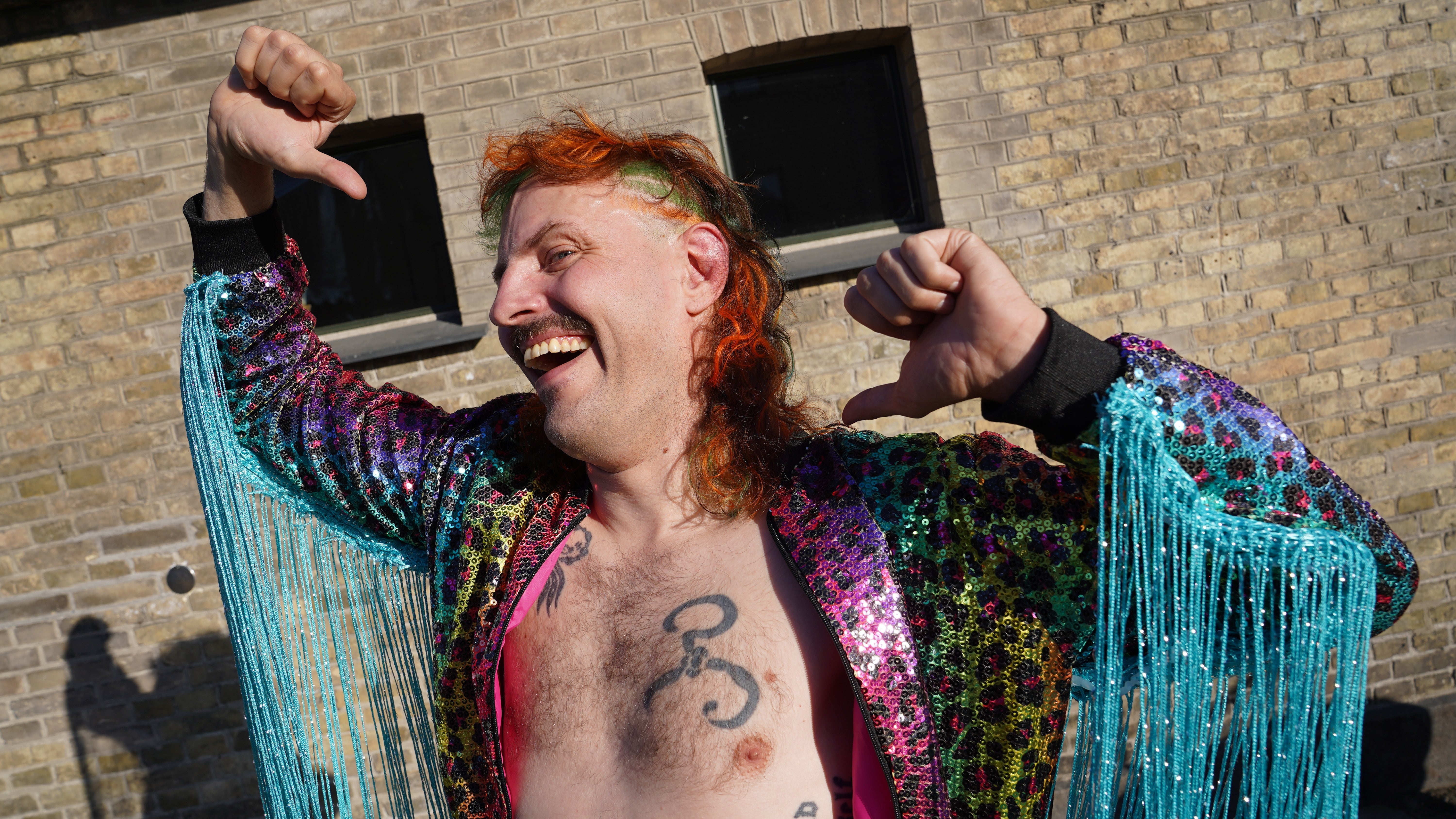 Natjecatelj Martin Sedolf nastupa kao karakterni profesionalni hrvač 'Benny Bacchus', na danskom Mullet prvenstvu u središtu Kopenhagena, u subotu, 6. lipnja 2026. (AP Photo/James Brooks)