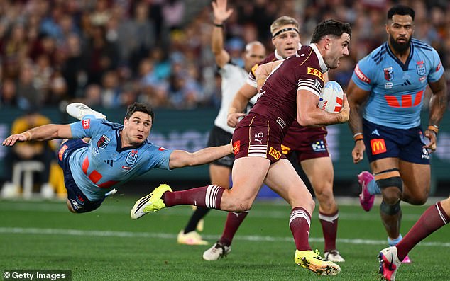 MELBOURNE, AUSTRALIJA - 17. LIPNJA: Trent Loiero iz Maroonsa prolazi loptom pored Mitchella Mosesa iz Bluesa tijekom druge utakmice serije Men's State of Origin između New South Wales Bluesa i Queensland Maroonsa na Melbourne Cricket Groundu 17. lipnja 2026. u Melbourneu, Australija. (Fotografija Quinn Rooney/Getty Images)