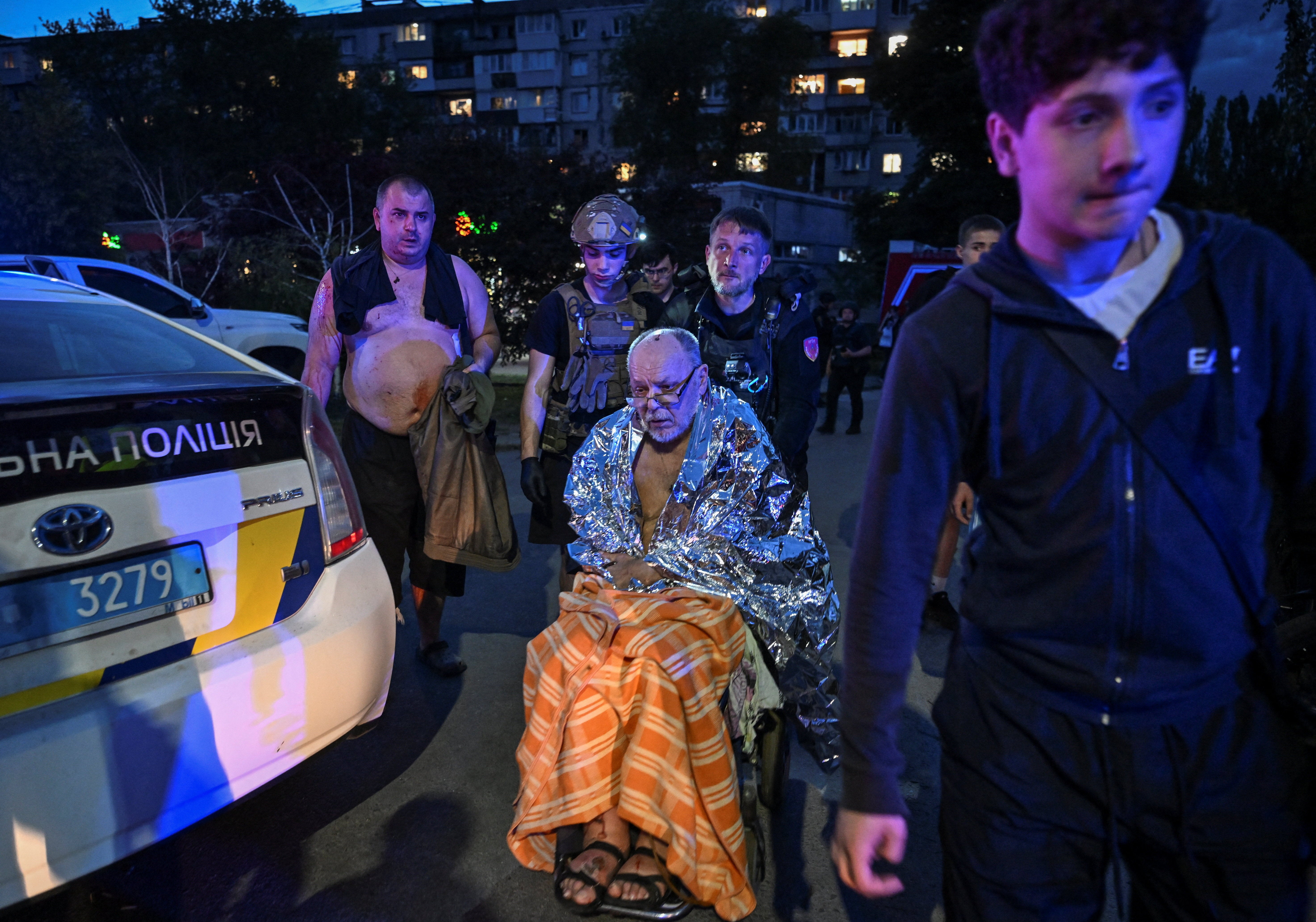 Medicinski radnici i volonteri evakuiraju ranjene stanovnike s mjesta stambene zgrade uništene u napadu ruske bespilotne letjelice, usred ruskog napada na Ukrajinu, u Zaporožju, Ukrajina, 4. lipnja 2026.