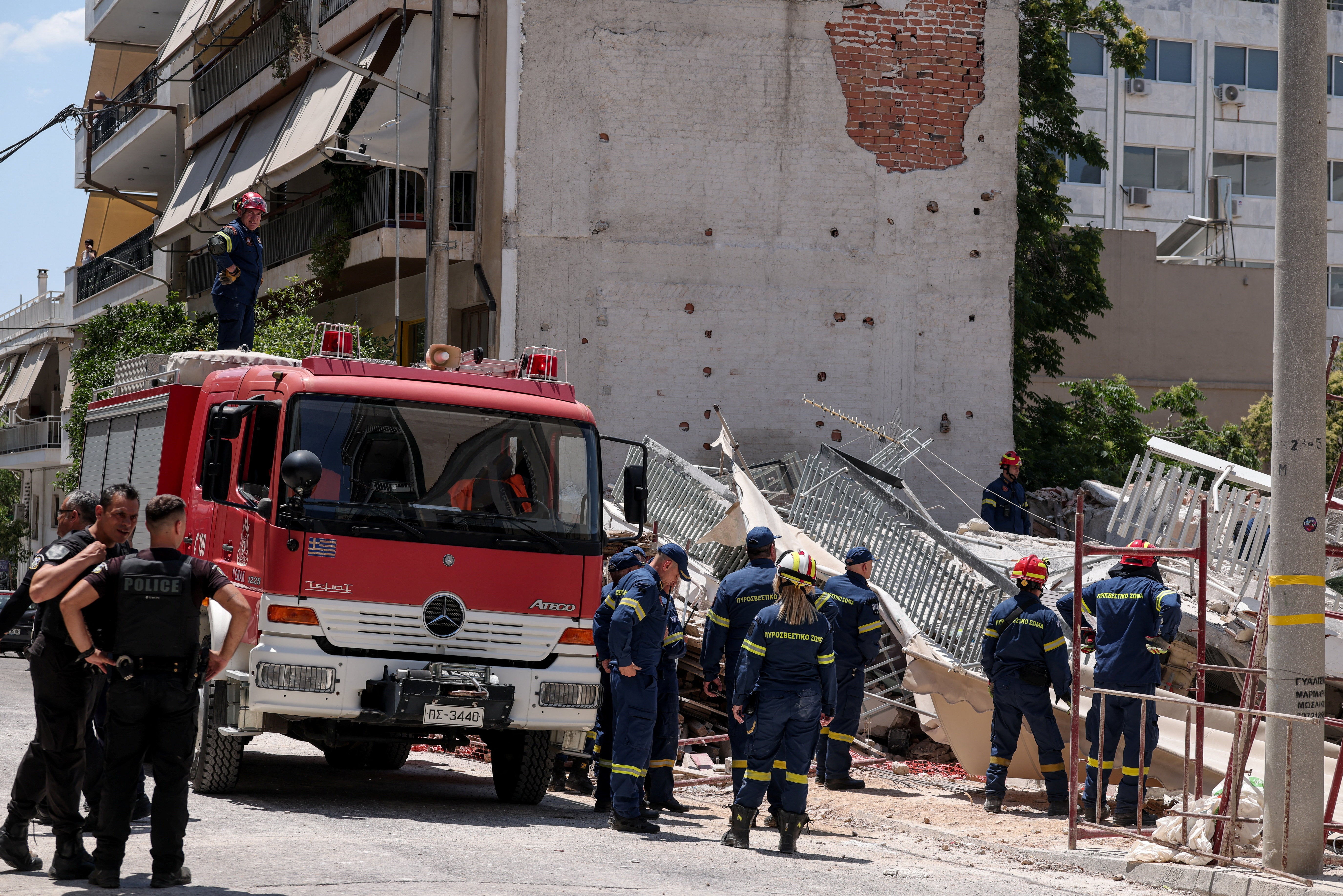 Osoblje za hitne slučajeve radi na mjestu urušavanja zgrade u četvrti Petralona u Ateni