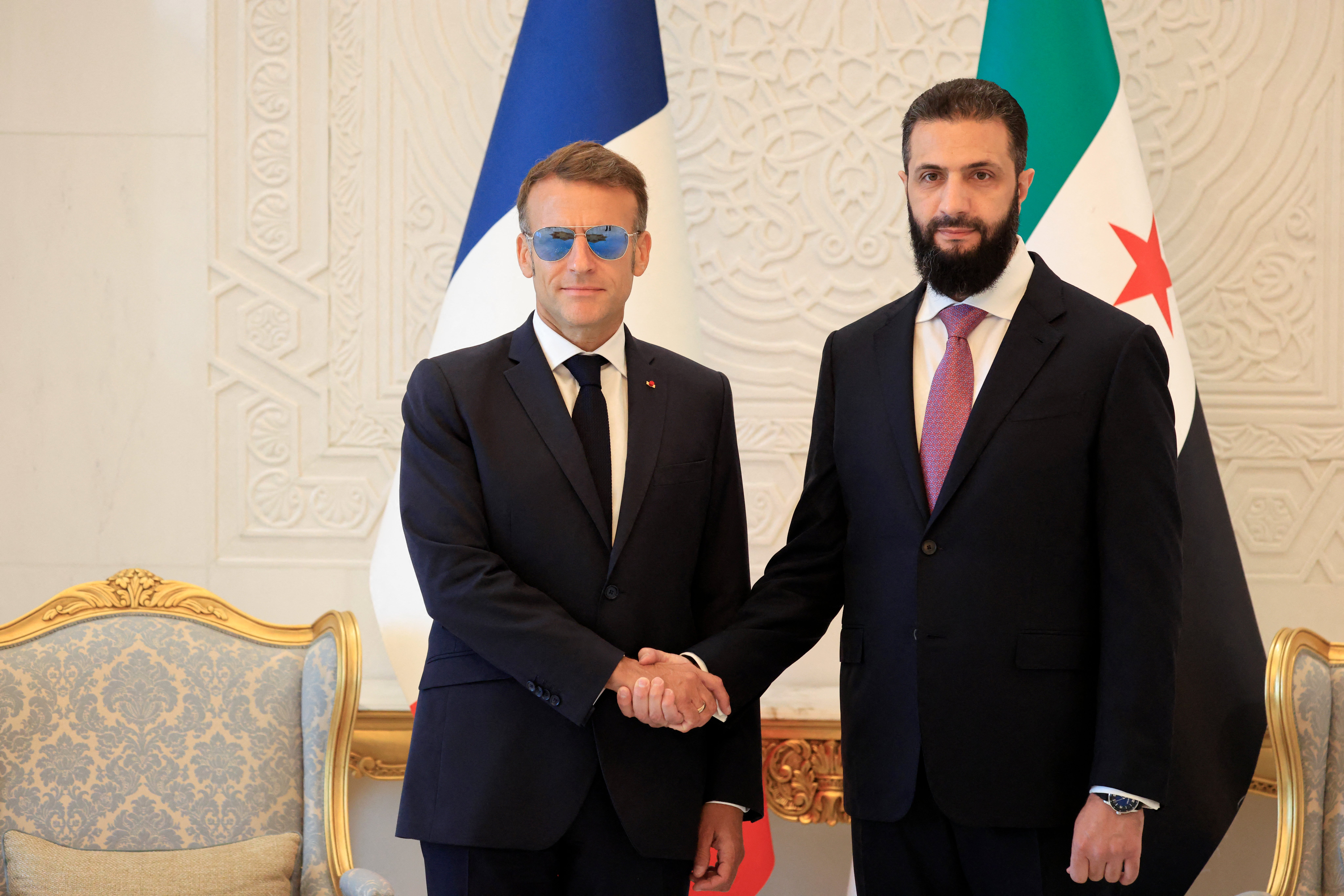 Francuski predsjednik Emmanuel Macron (L) rukuje se sa sirijskim predsjednikom Ahmedom al-Sharaaom uoči njihova sastanka u Narodnoj palači u Damasku