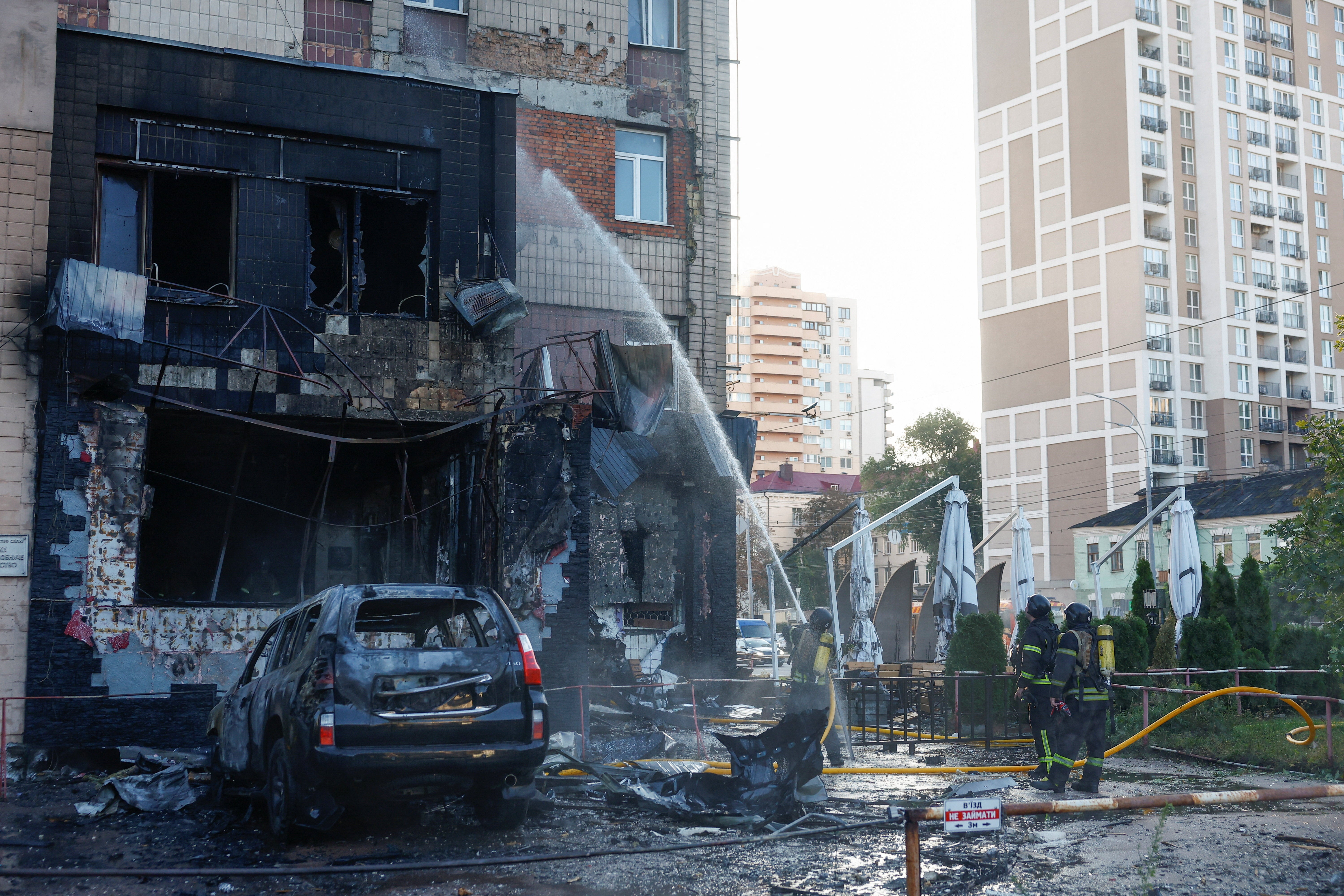 Firefighters work at the site of a cafe which was hit by a Russian drone strike, amid Russia's attack on Ukraine, in Kyiv, Ukraine 28 September 2026