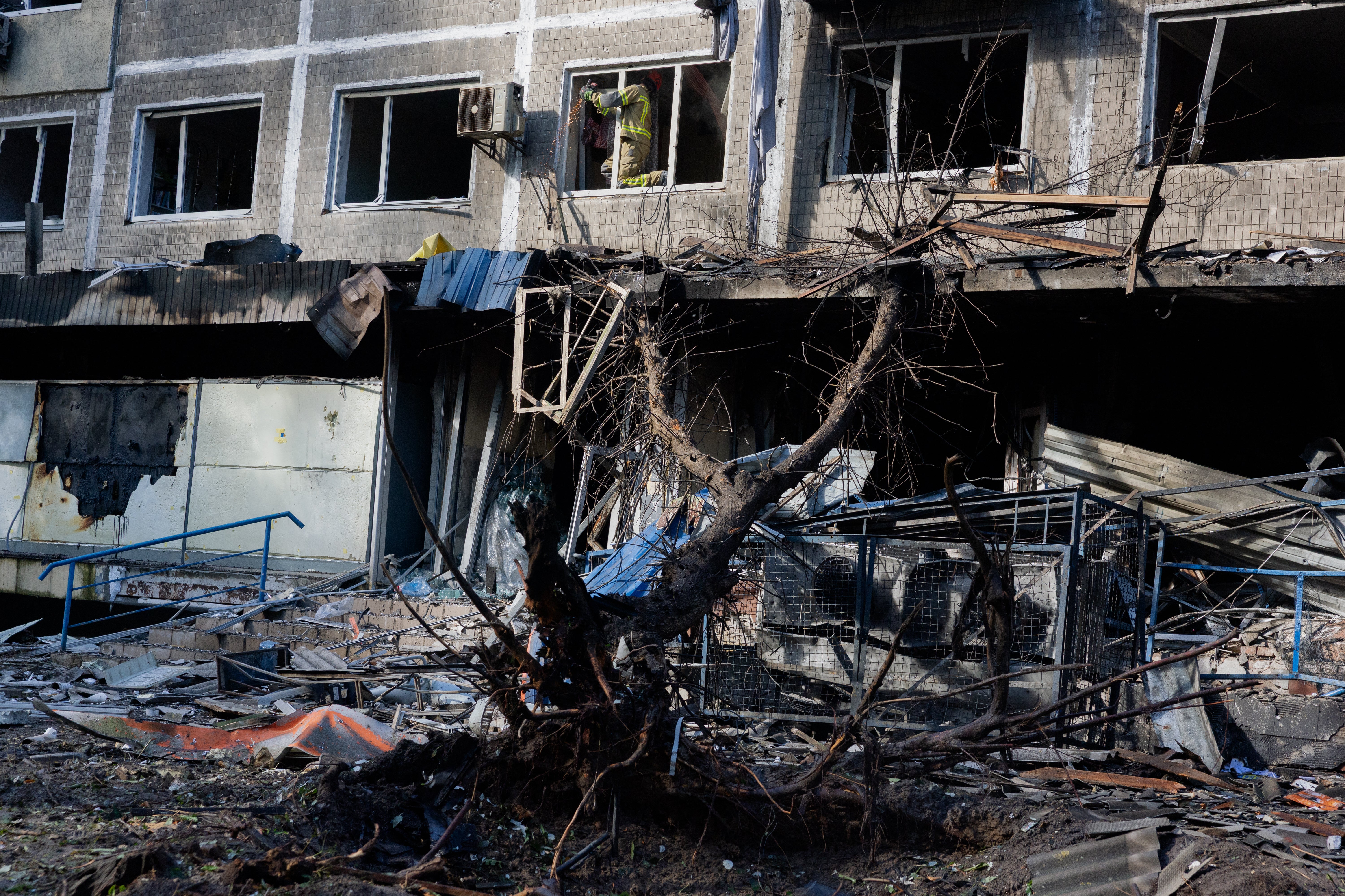 Rescue workers are seen at the site of a damaged residential building following a drone strike in Kyiv on 26 September 2026