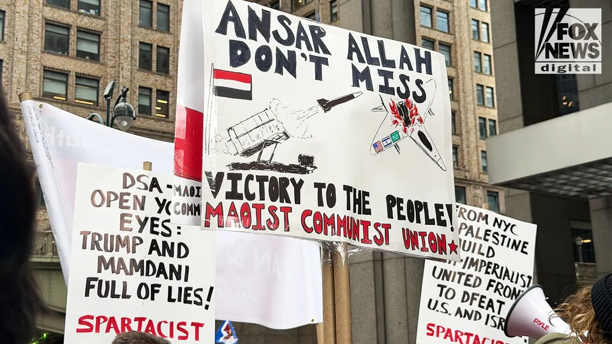 Maoist Communist Union and Spartacist League signs displayed at an anti-Israel protest in New York City.