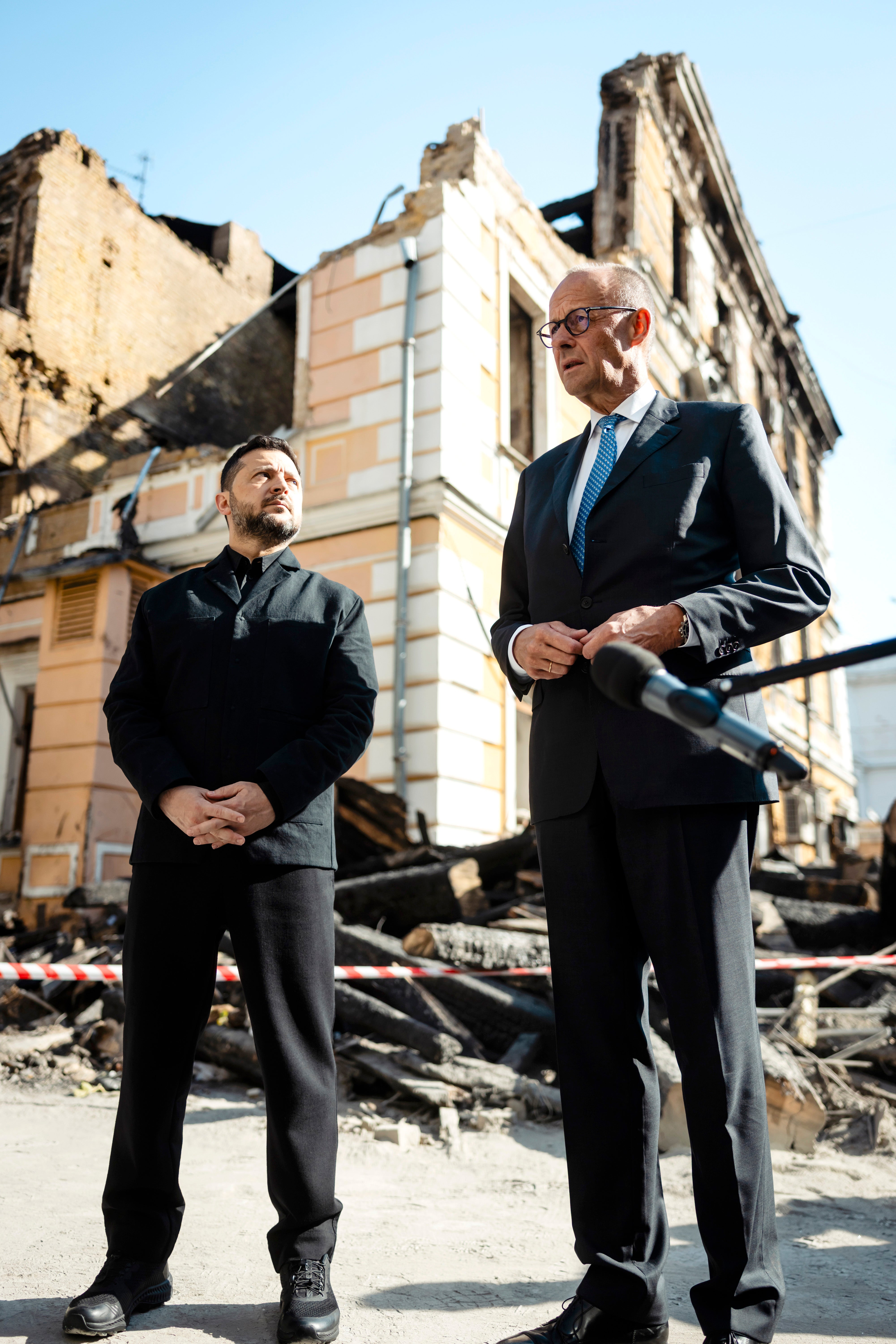 President of Ukraine, Volodymyr Zelenskyy and Chancellor Friedrich Merz visit the site of a Russian air strike on October 4