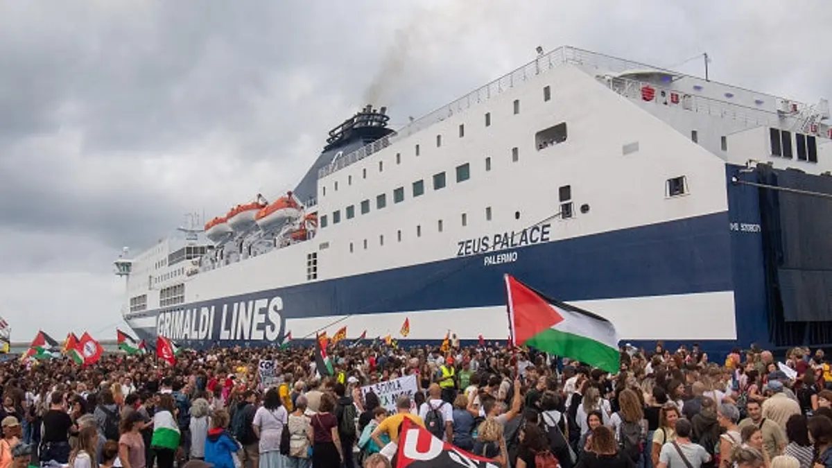 Dockworkers and students march through a port gate during a Gaza and Palestine protest in Livorno, Italy.